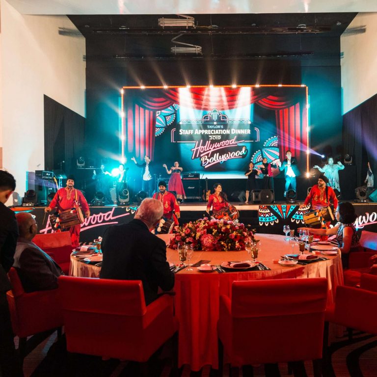 A large room adorned with red chairs and tables, prepared for the Taylor's University Staff Appreciation Dinner 2019.