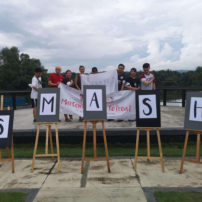 Attendees stand before a "SMASH" sign at the Taylor's University MarComm Smash Retreat.