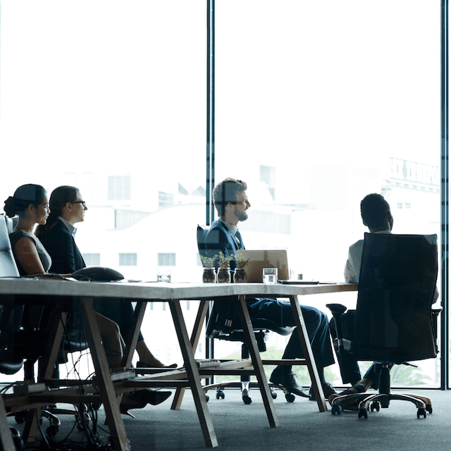 Several people gathered at a table, sharing ideas and enjoying each other's company in a collaborative setting.